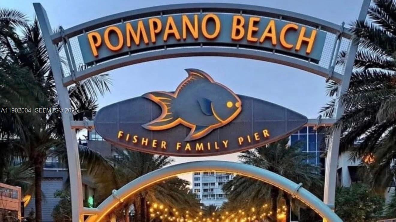 3221 Northeast 7th Street, Unit 2 Pompano Beach, FL 33062 - Photo 9 of 10 a sign that is on the side of a street