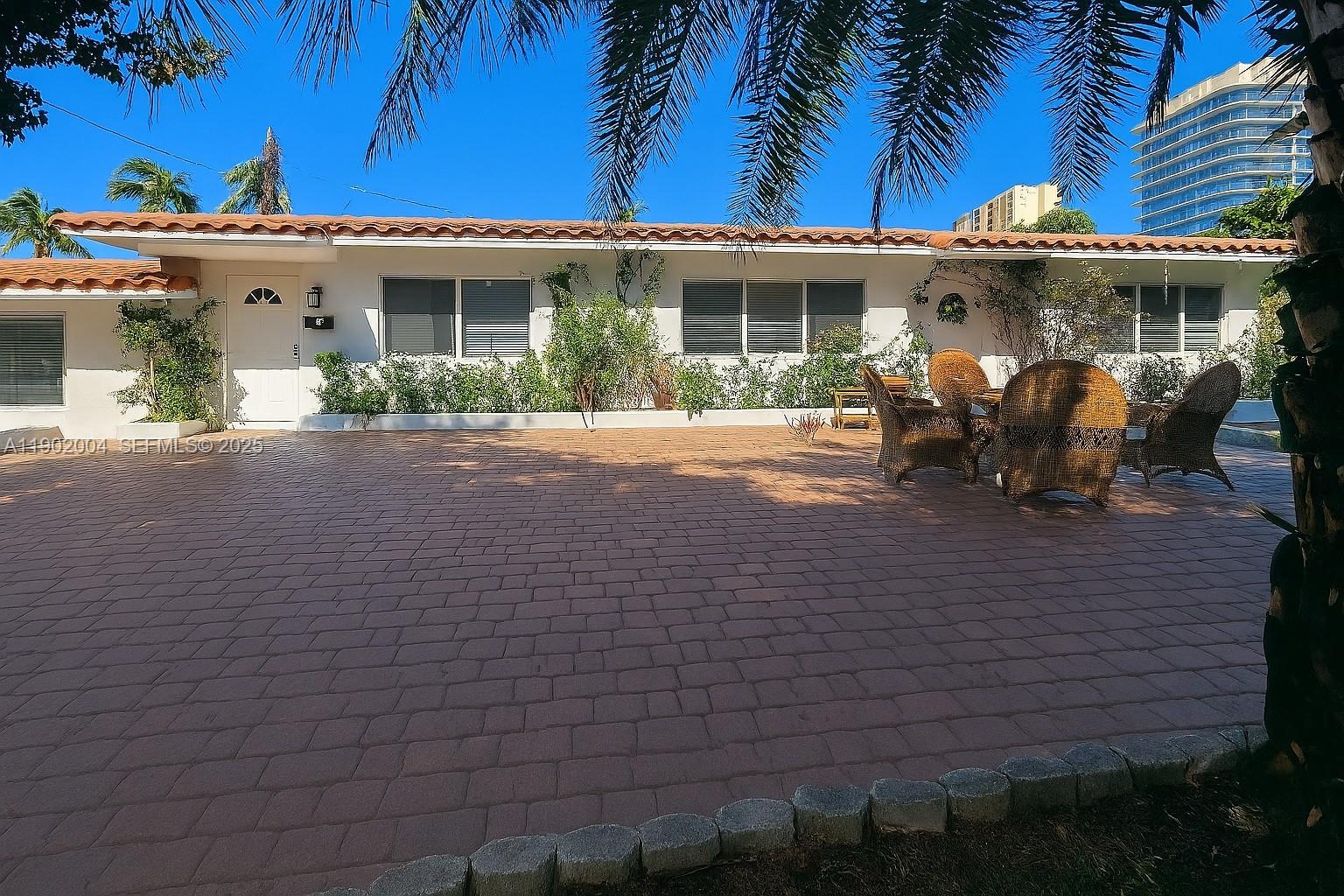 3221 Northeast 7th Street, Unit 2 Pompano Beach, FL 33062 - Photo 10 of 10 a view of a white building among the house with potted plants