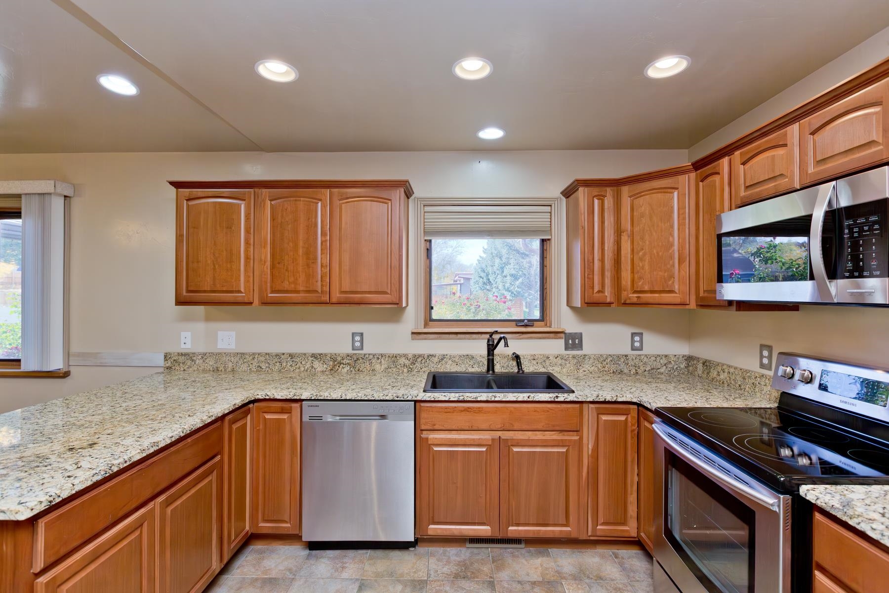 431 Pleasant Ridge Lane, Unit A Grand Junction, CO 81507 - Photo 12 of 29 a kitchen with granite countertop a sink cabinets and window