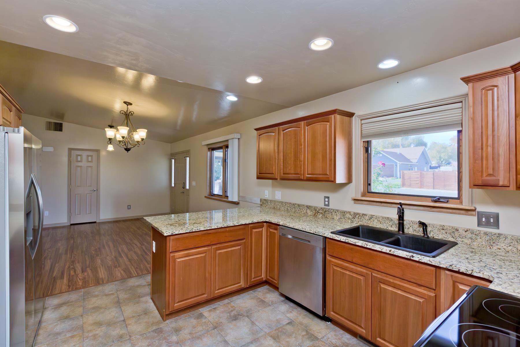 431 Pleasant Ridge Lane, Unit A Grand Junction, CO 81507 - Photo 13 of 29 a kitchen with granite countertop a sink stainless steel appliances and cabinets