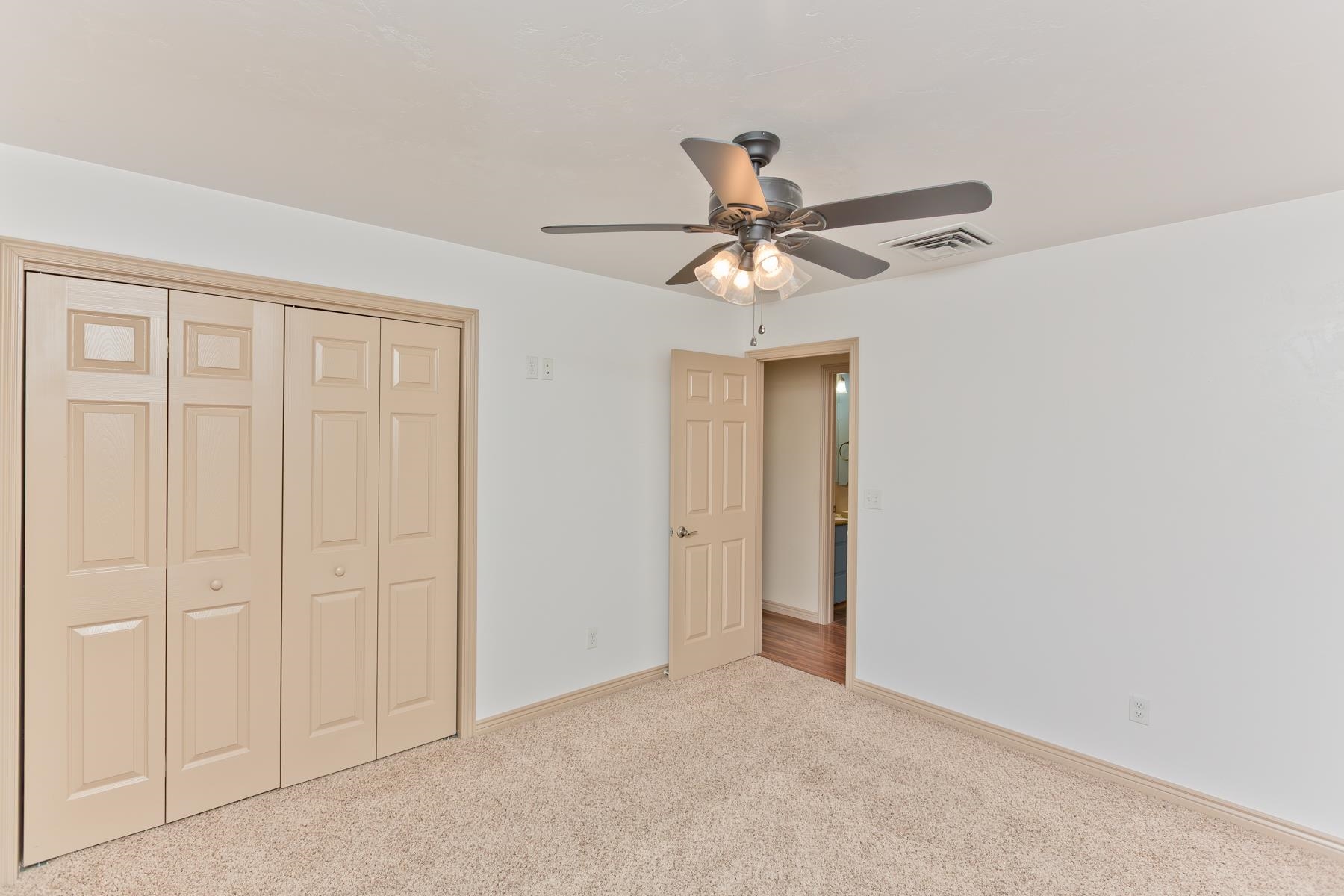 431 Pleasant Ridge Lane, Unit A Grand Junction, CO 81507 - Photo 20 of 29 an empty room with a ceiling fan and a window