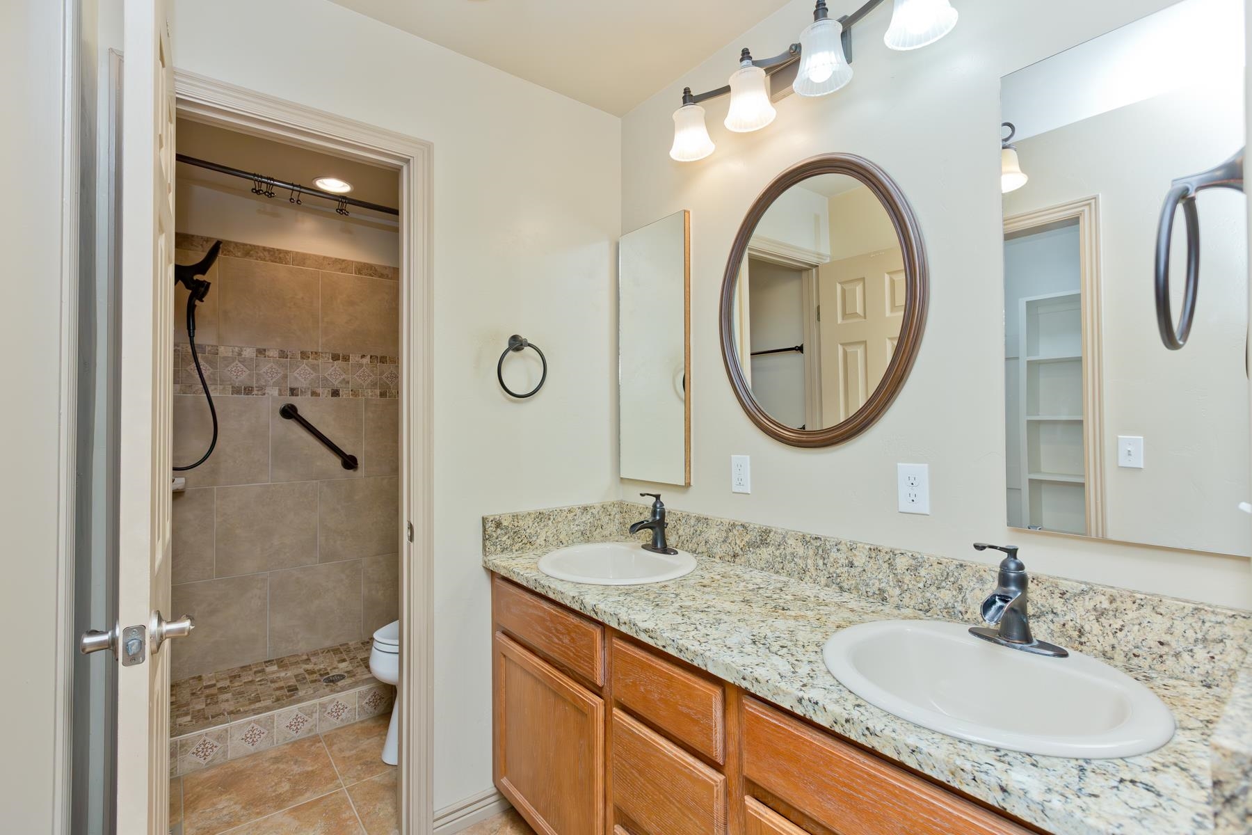 431 Pleasant Ridge Lane, Unit A Grand Junction, CO 81507 - Photo 26 of 29 a bathroom with a granite countertop double vanity sink and a mirror