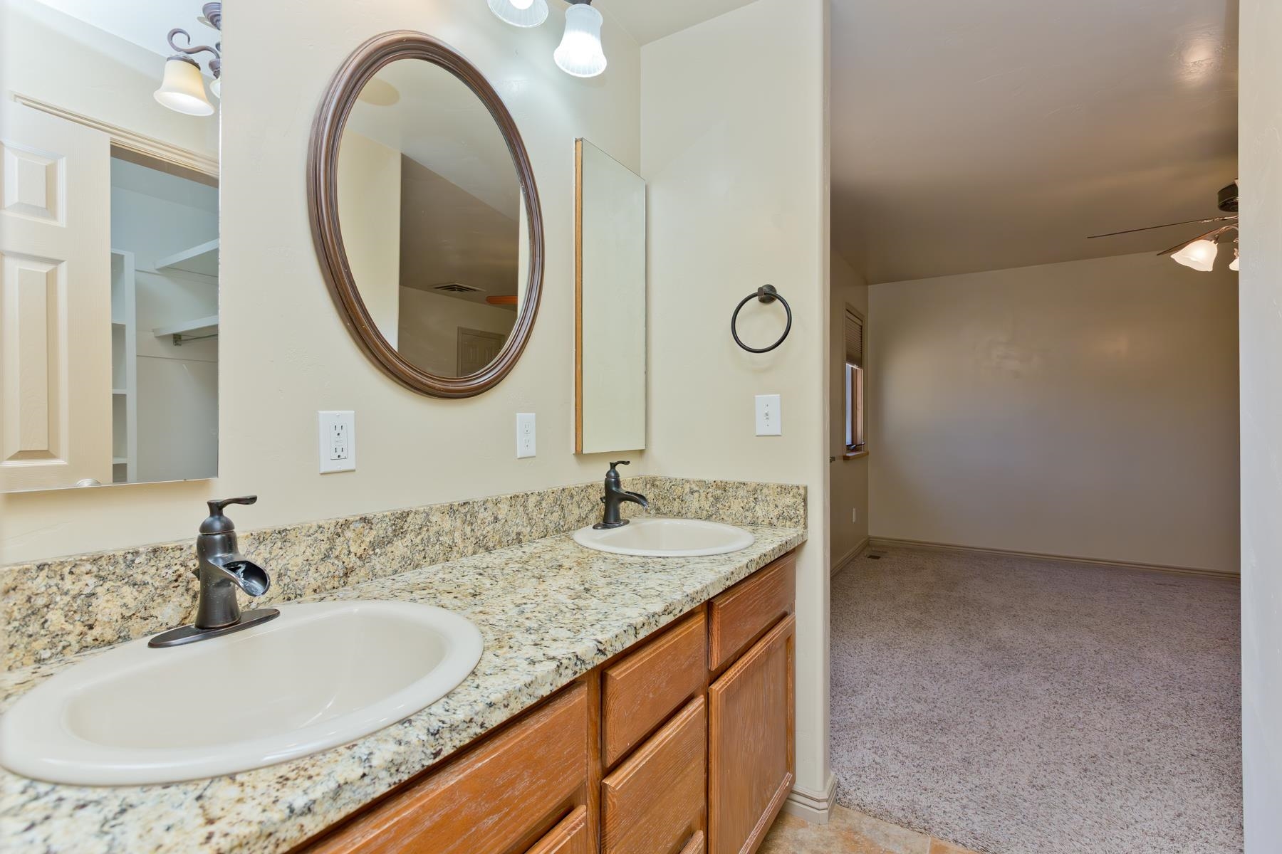 431 Pleasant Ridge Lane, Unit A Grand Junction, CO 81507 - Photo 27 of 29 a bathroom with a granite countertop sink and a mirror