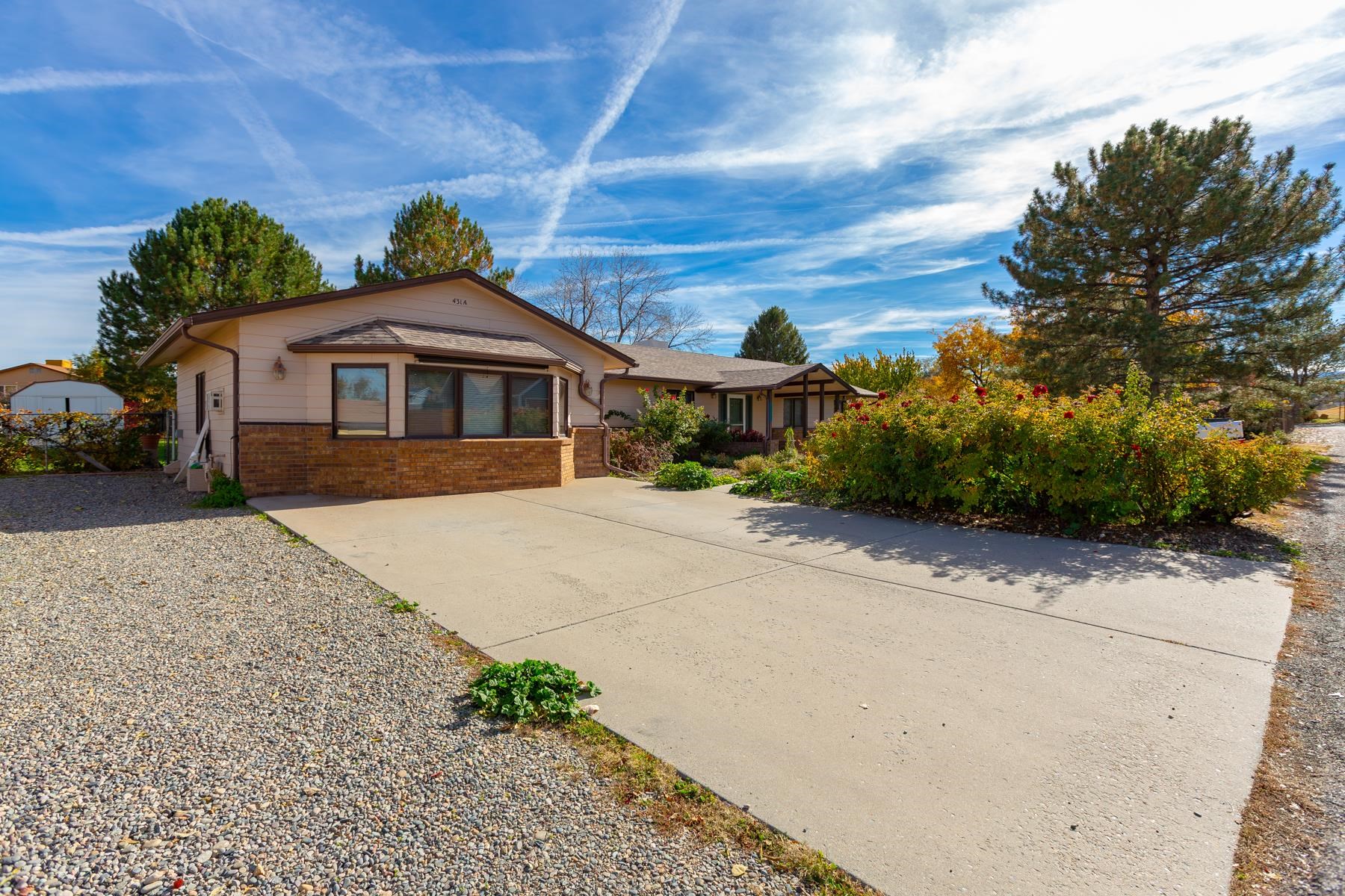 431 Pleasant Ridge Lane, Unit A Grand Junction, CO 81507 - Photo 3 of 29 a front view of a house with a yard and trees