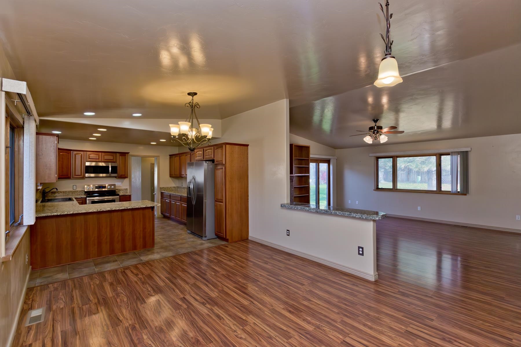 431 Pleasant Ridge Lane, Unit A Grand Junction, CO 81507 - Photo 7 of 29 a kitchen with stainless steel appliances granite countertop a refrigerator a stove and a wooden floors