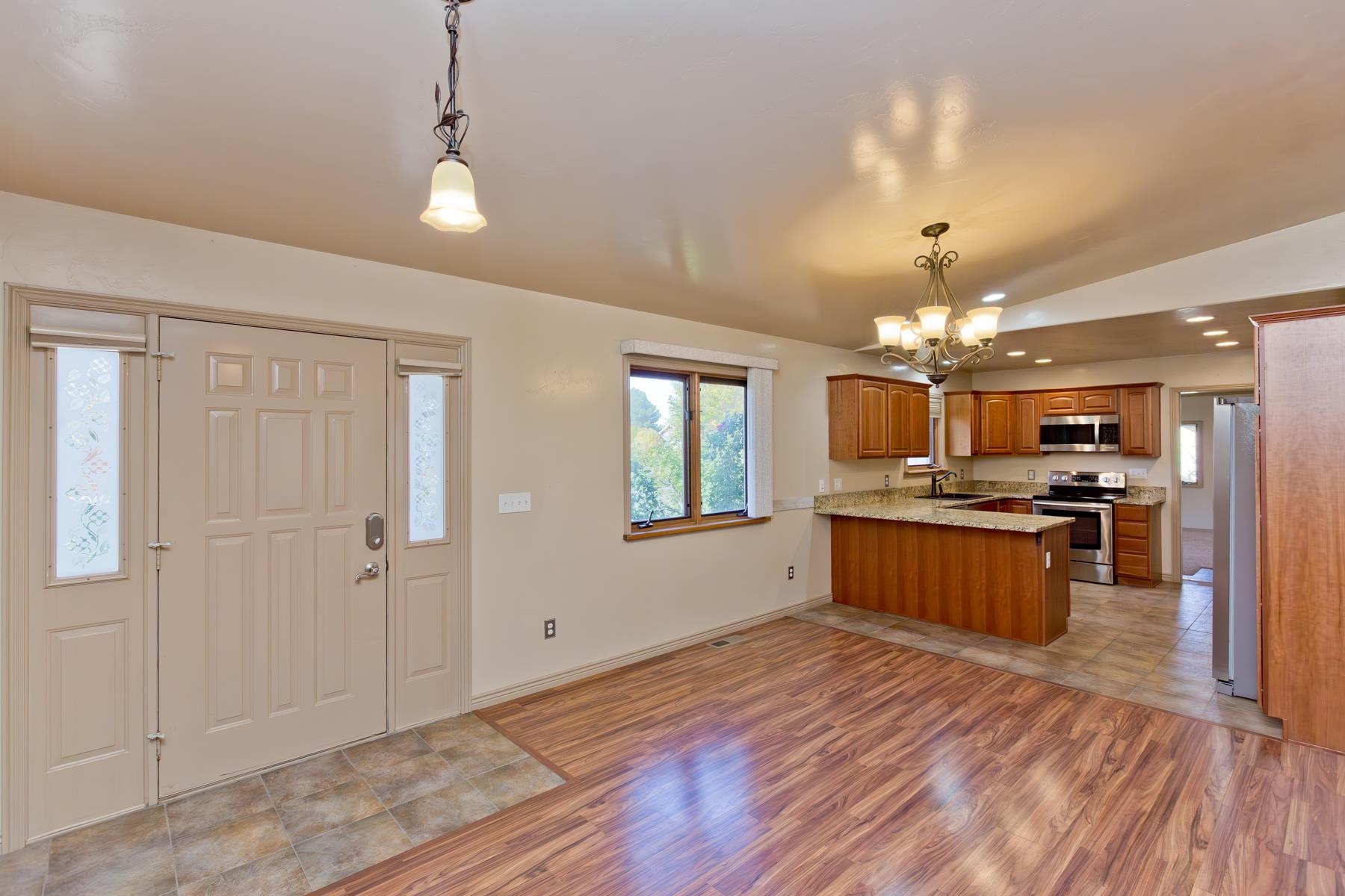 431 Pleasant Ridge Lane, Unit A Grand Junction, CO 81507 - Photo 9 of 29 a large kitchen with kitchen island a sink stainless steel appliances and cabinets