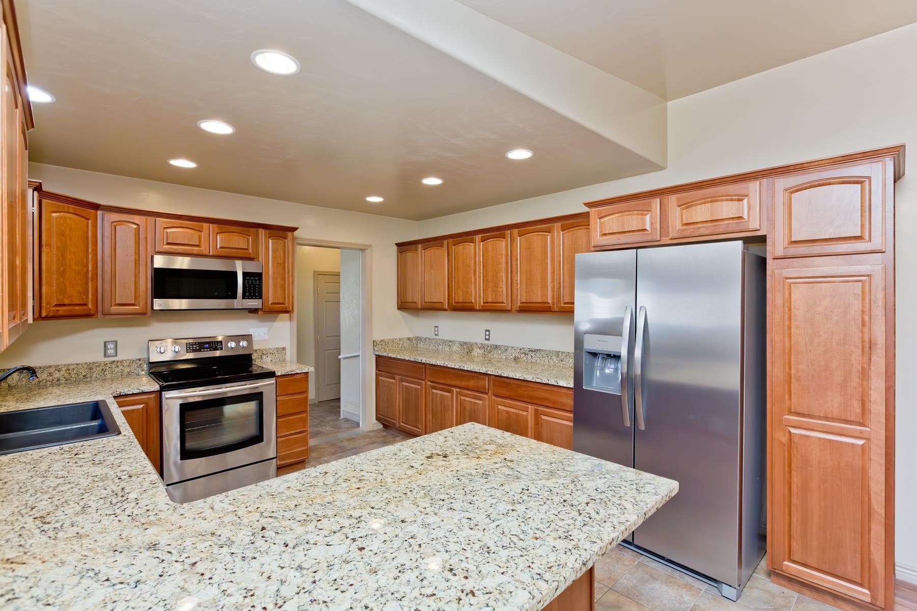 431 Pleasant Ridge Lane, Unit A Grand Junction, CO 81507 - Photo 10 of 29 a kitchen with stainless steel appliances granite countertop a refrigerator a stove top oven a sink and dishwasher
