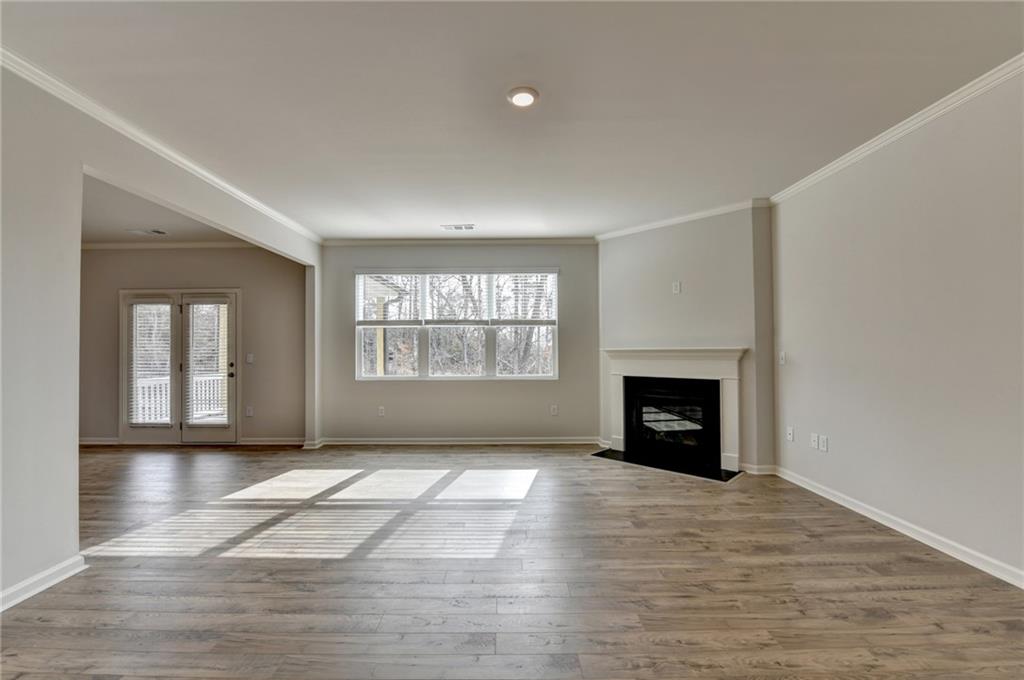 4067 Peregrine Way Gainesville, GA 30506 - Photo 13 of 52 wooden floor fireplace and windows in a room