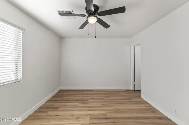a view of room with wooden floor