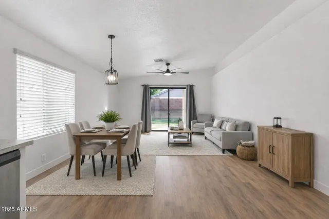 a dining room with furniture and wooden floor
