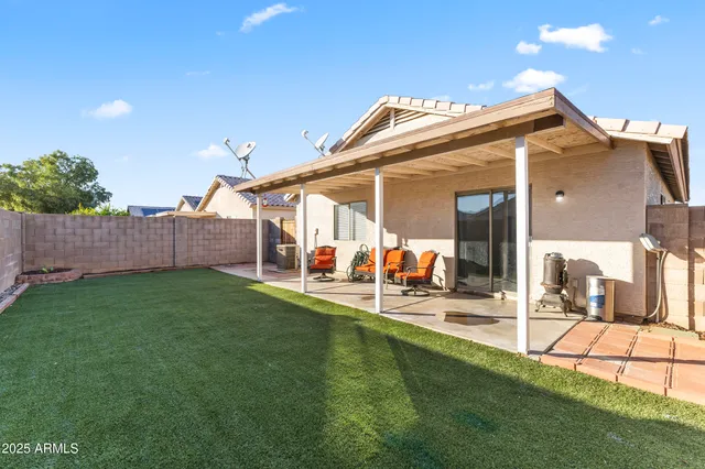 a view of a house with a yard and sitting area