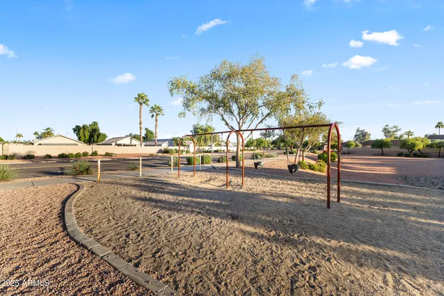 a view of a yard with wooden fence