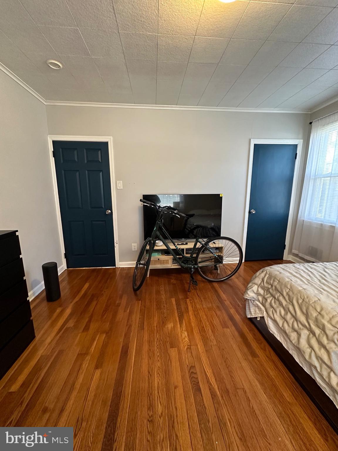 221 West Chester Pike, Unit B Ridley Park, PA 19078 - Photo 12 of 18 a bedroom with a bed and wooden floor
