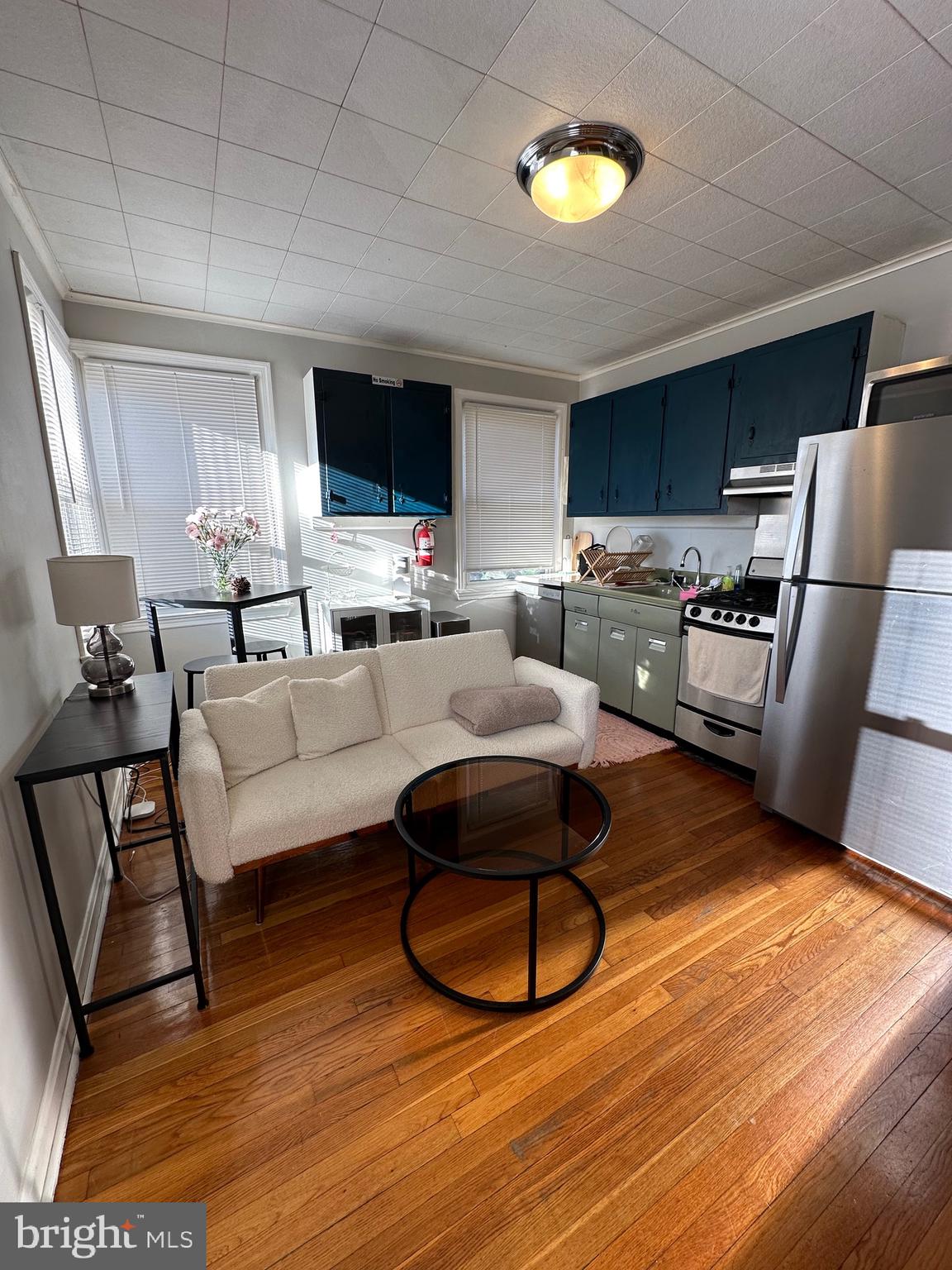 221 West Chester Pike, Unit B Ridley Park, PA 19078 - Photo 2 of 18 a living room with furniture and a flat screen tv