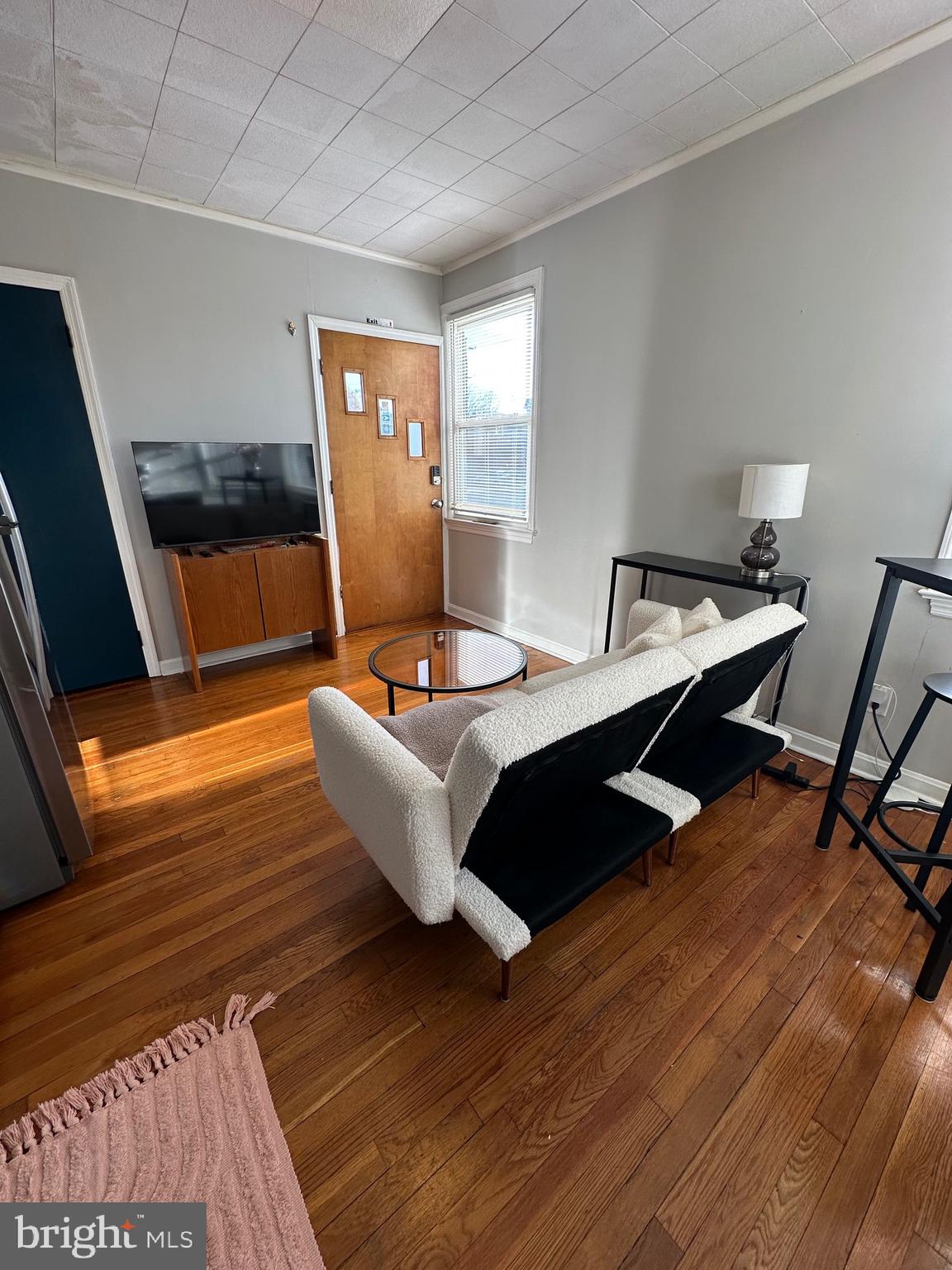 221 West Chester Pike, Unit B Ridley Park, PA 19078 - Photo 3 of 18 a living room with couch tv and wooden floor