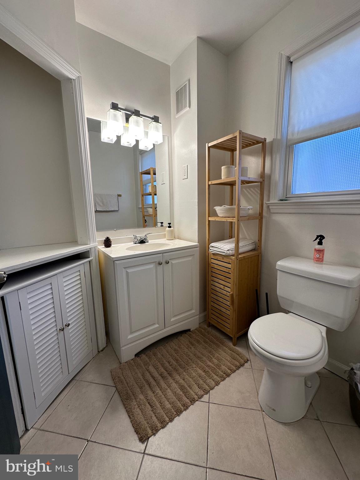 221 West Chester Pike, Unit B Ridley Park, PA 19078 - Photo 8 of 18 a bathroom with a sink a toilet and a mirror