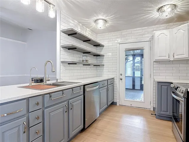 a kitchen with a sink cabinets and appliances