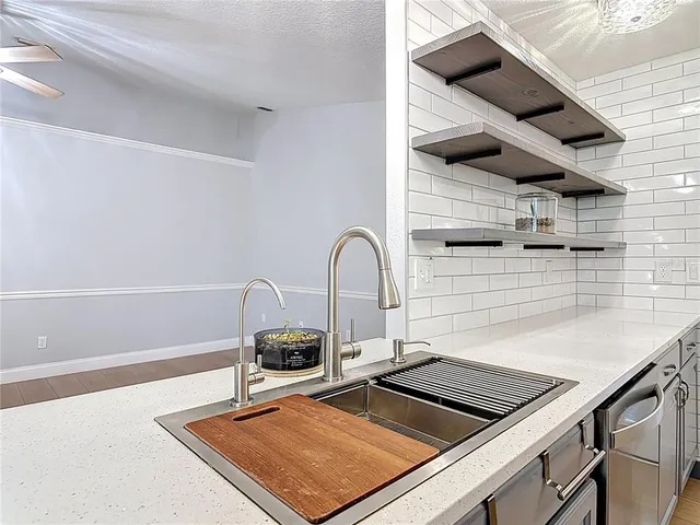 a close view of a sink a counter and appliances in the kitchen