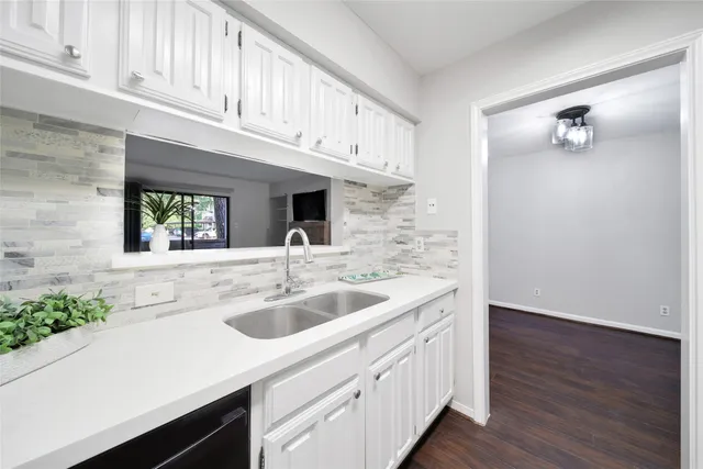 a kitchen with stainless steel appliances granite countertop a sink and dishwasher with wooden floor