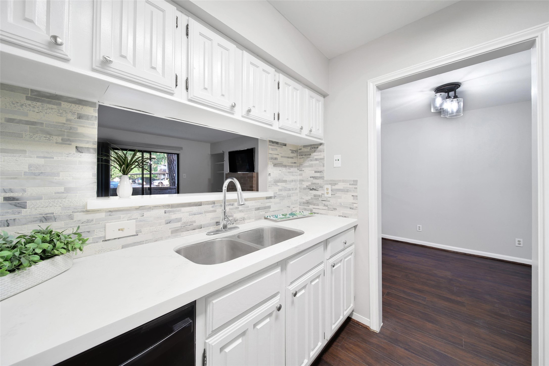 a kitchen with stainless steel appliances granite countertop a sink and dishwasher with wooden floor