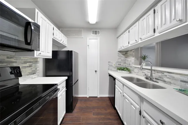 a kitchen with a sink and steel appliances