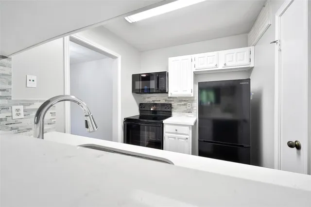 a kitchen with a refrigerator and a sink