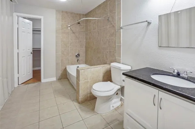 a white toilet sitting next to a bathroom sink