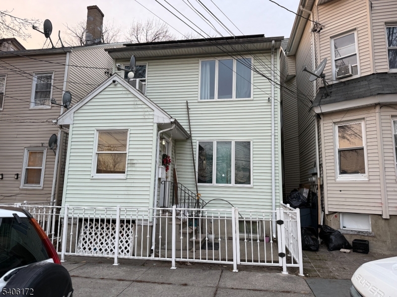 77 Garfield Avenue, Unit 2 Paterson, NJ 07522 - Photo 1 of 8 a view of a house with a small car and a car parked beside it