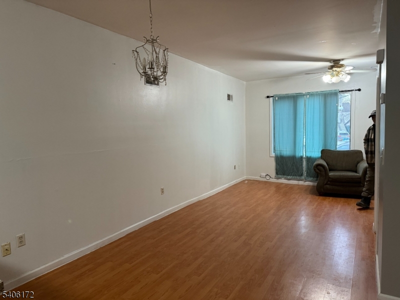 77 Garfield Avenue, Unit 2 Paterson, NJ 07522 - Photo 2 of 8 a room with a couch and wooden floor