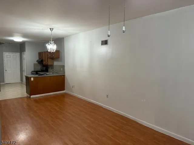 a view of a kitchen with a sink and a refrigerator