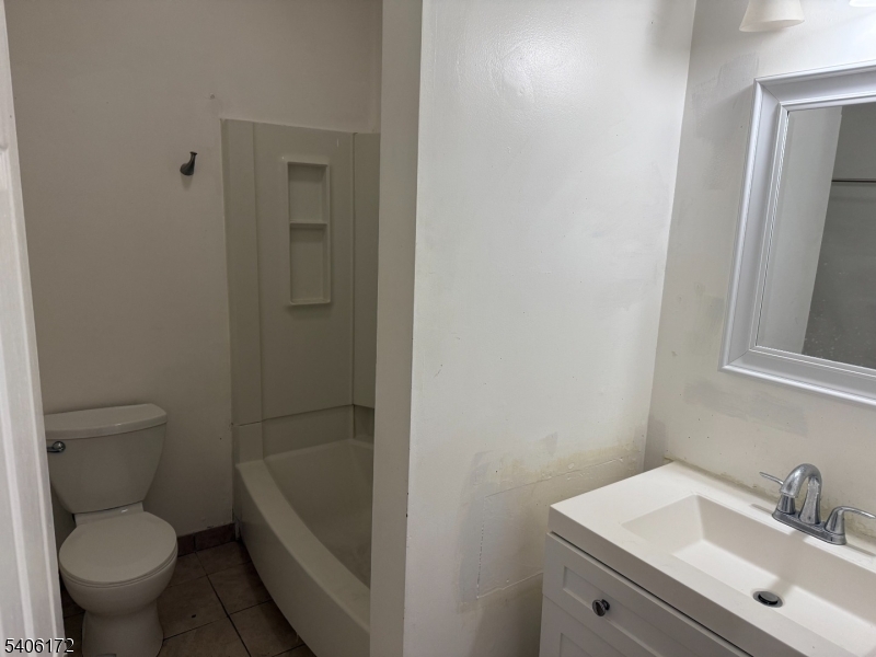 77 Garfield Avenue, Unit 2 Paterson, NJ 07522 - Photo 5 of 8 a bathroom with a sink toilet and shower