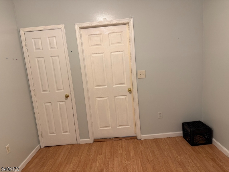 77 Garfield Avenue, Unit 2 Paterson, NJ 07522 - Photo 6 of 8 an empty room with wooden floor and closet