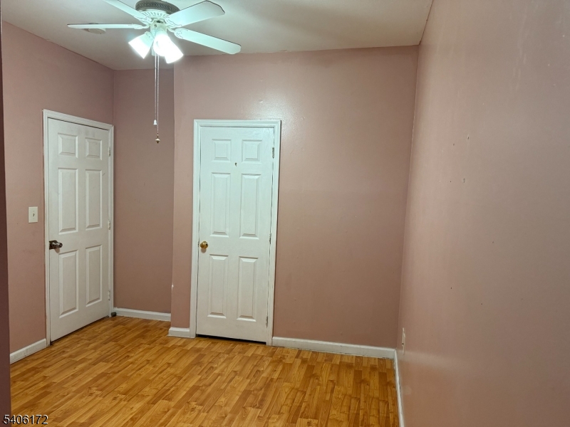 77 Garfield Avenue, Unit 2 Paterson, NJ 07522 - Photo 7 of 8 a view of an empty room with window and chandelier fan