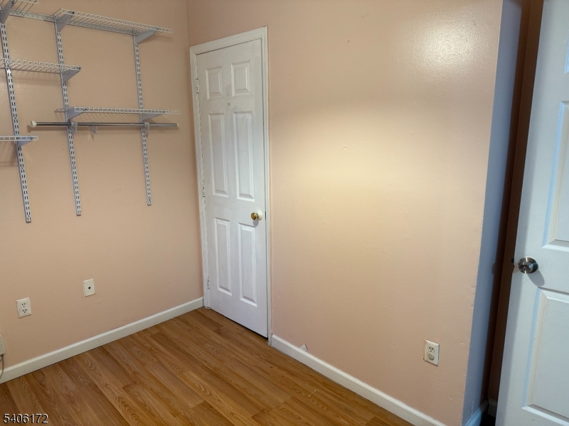77 Garfield Avenue, Unit 2 Paterson, NJ 07522 - Photo 8 of 8 a view of an empty room with wooden floor and a window