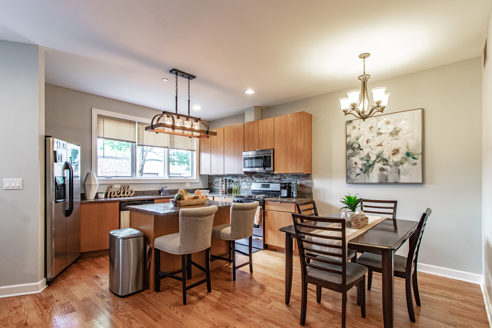 48 Northfield Terrace Wheeling, IL 60090 - Photo 11 of 36 a dining room filled chandelier and wooden floor