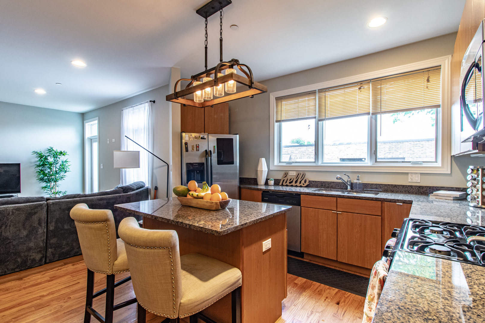 48 Northfield Terrace Wheeling, IL 60090 - Photo 15 of 36 a kitchen with stainless steel appliances granite countertop a stove a sink a refrigerator a dining table and chairs with wooden floor