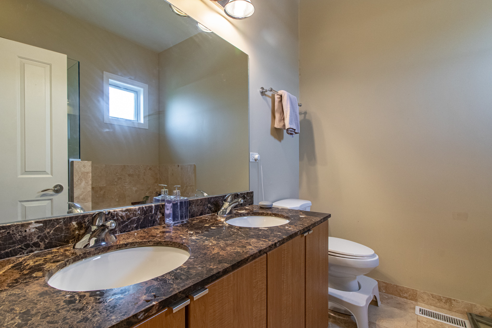 48 Northfield Terrace Wheeling, IL 60090 - Photo 21 of 36 a bathroom with a granite countertop sink a toilet and a mirror