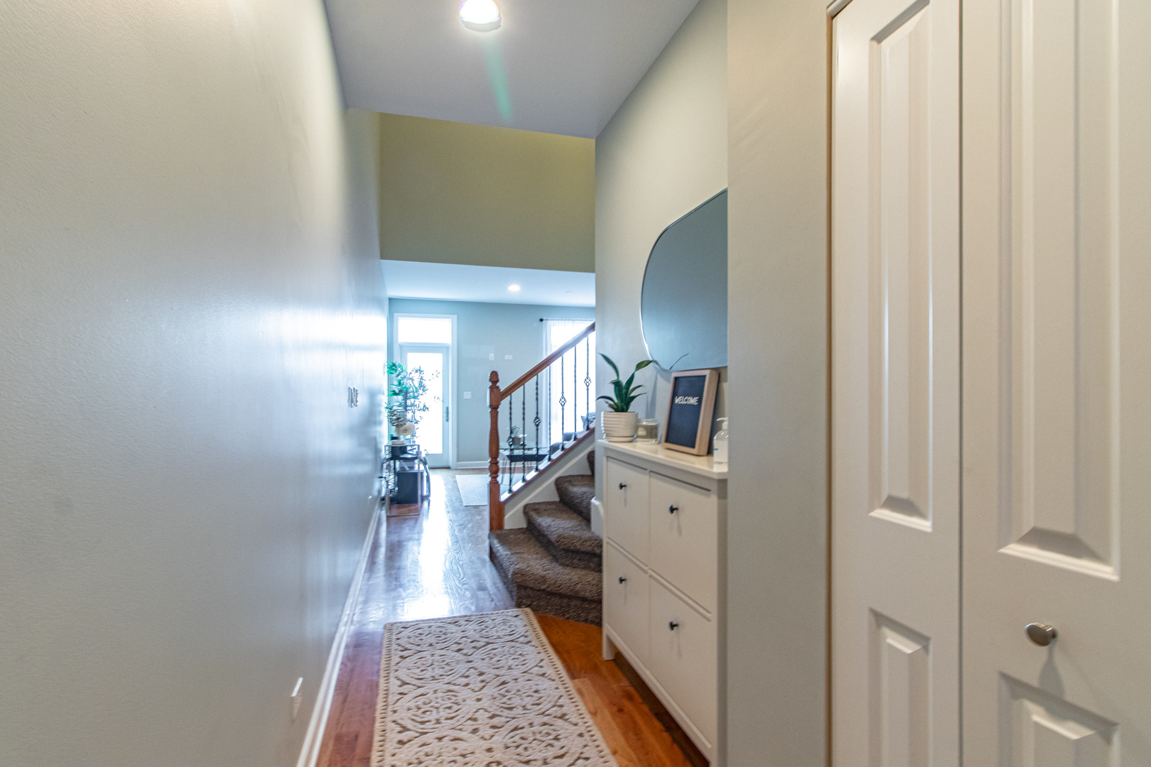 48 Northfield Terrace Wheeling, IL 60090 - Photo 5 of 36 a hallway with white cabinets and wooden floor