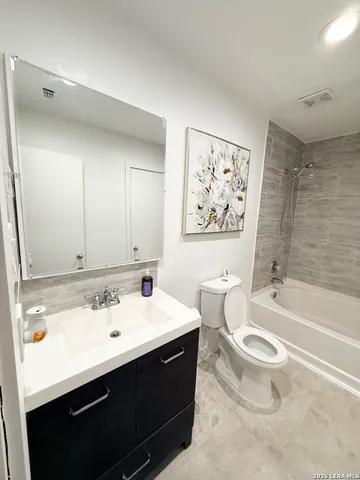 a bathroom with a sink a toilet and a bathtub