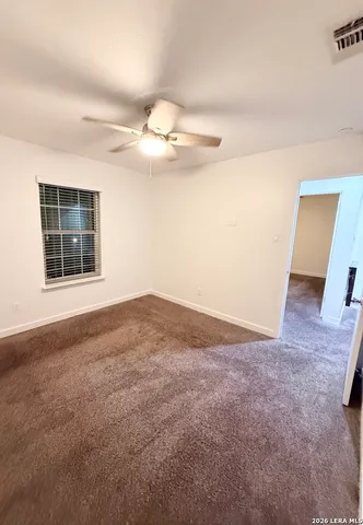 a view of backyard with wooden fence