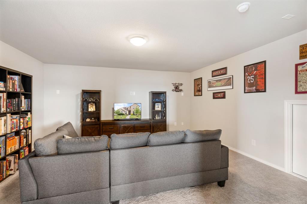 321 Pasture Drive Midlothian, TX 76065 - Photo 24 of 40 a living room with furniture and a book shelf