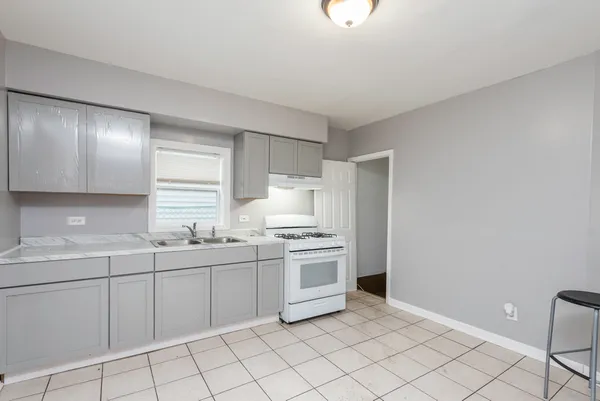 a kitchen with a sink cabinets and appliances