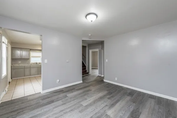 a view of an empty room and wooden floor