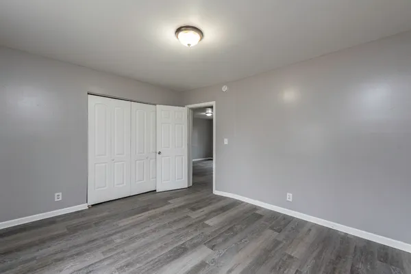 a view of an empty room and wooden floor