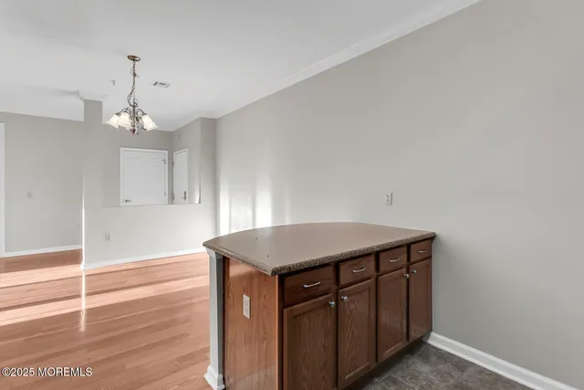a kitchen with a wooden floor and cabinets