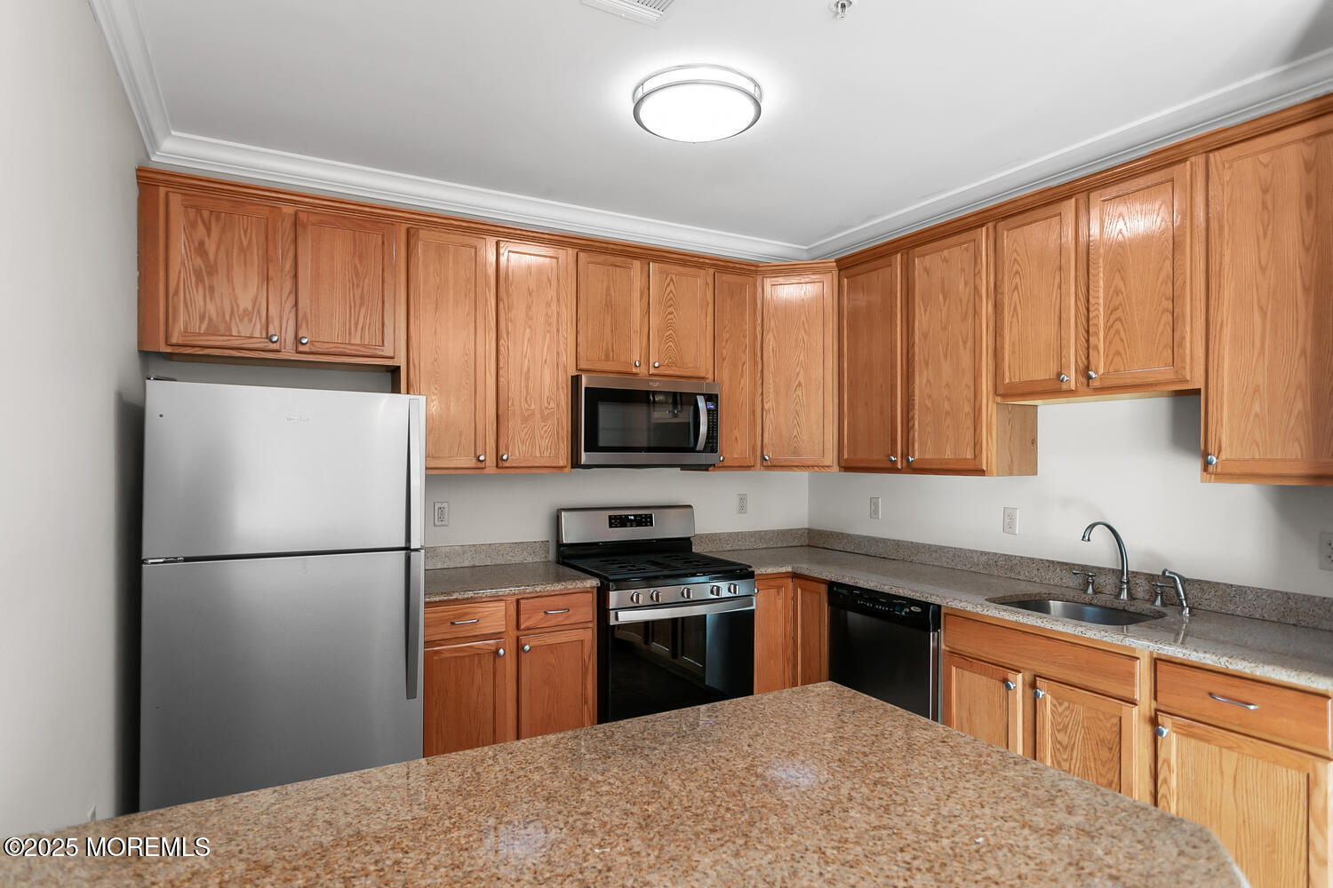 325 Regency Place Woodbridge, NJ 07095 - Photo 12 of 37 a kitchen with granite countertop stainless steel appliances a refrigerator a sink a stove a microwave and cabinets