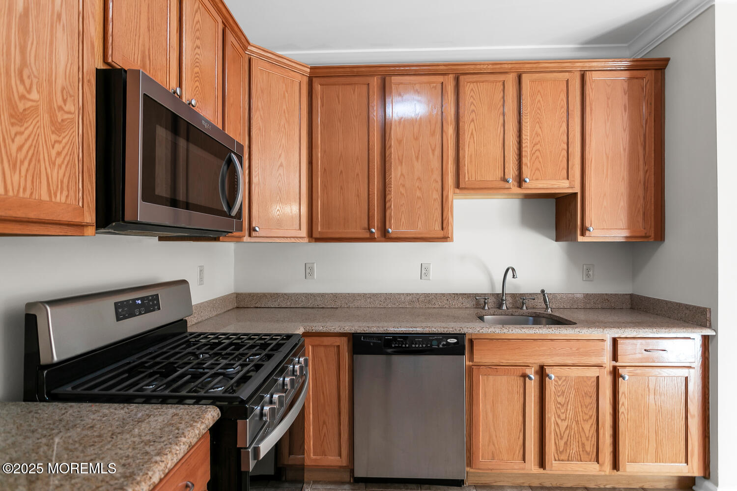 325 Regency Place Woodbridge, NJ 07095 - Photo 16 of 37 a kitchen with stainless steel appliances granite countertop a stove a sink dishwasher and a microwave oven with cabinets