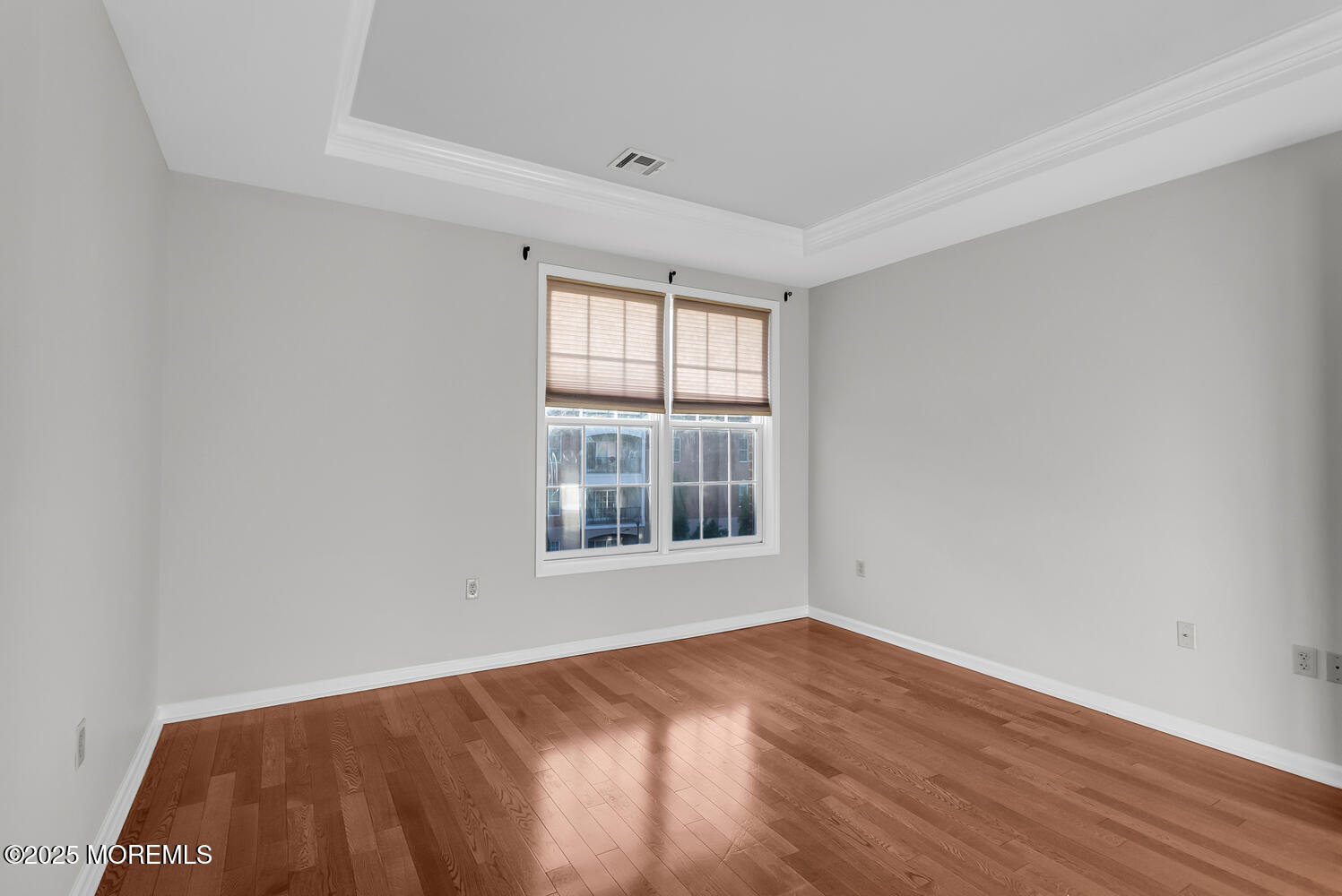 325 Regency Place Woodbridge, NJ 07095 - Photo 25 of 37 an empty room with wooden floor and windows