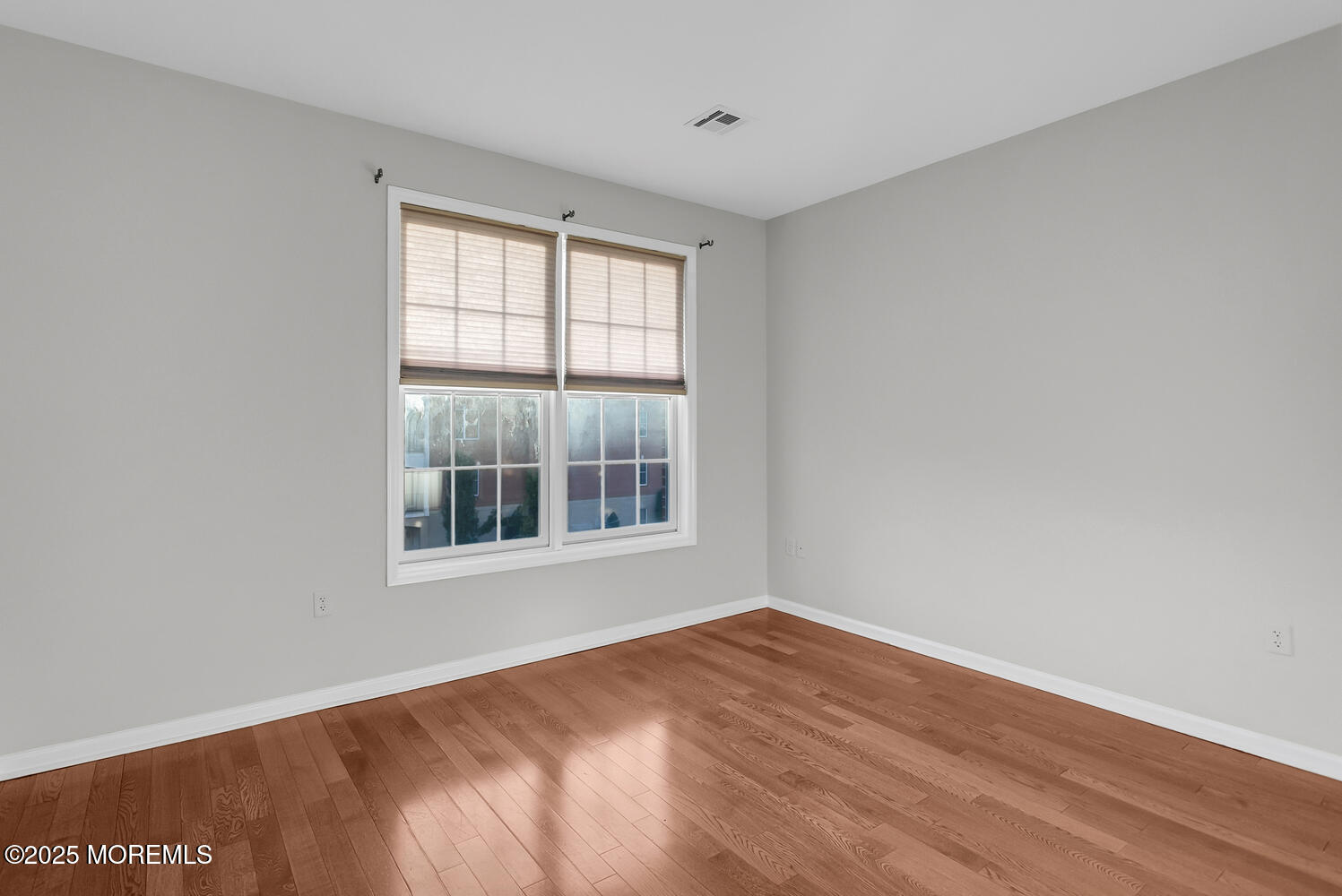325 Regency Place Woodbridge, NJ 07095 - Photo 26 of 37 an empty room with wooden floor and windows