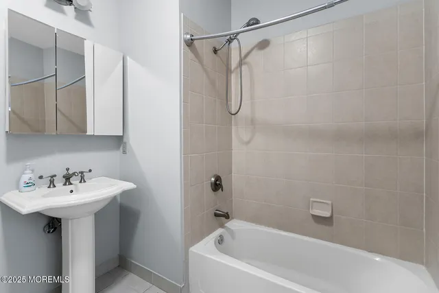 a white bath tub sitting next to a white sink